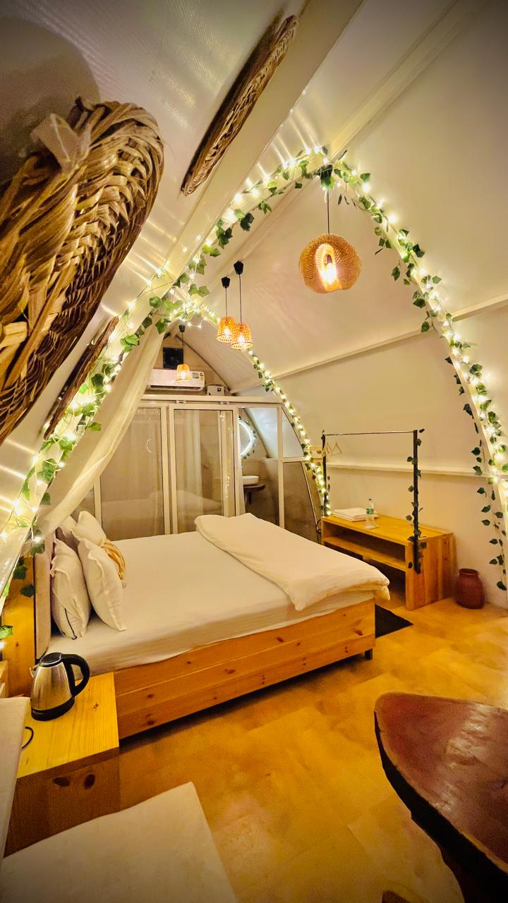 Arched cottage bedroom with fairy lights and cane lamps